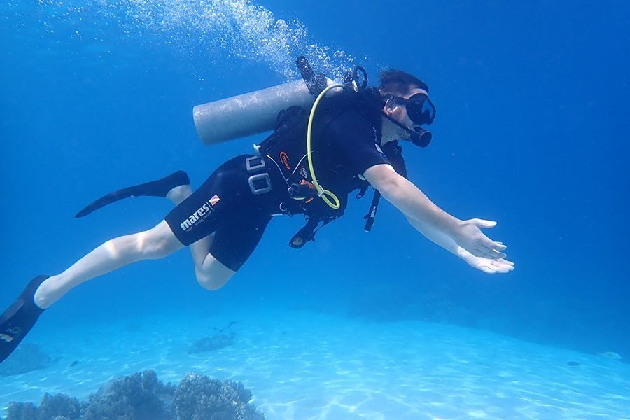Beginner trying scuba diving with an instructor at Menjangan